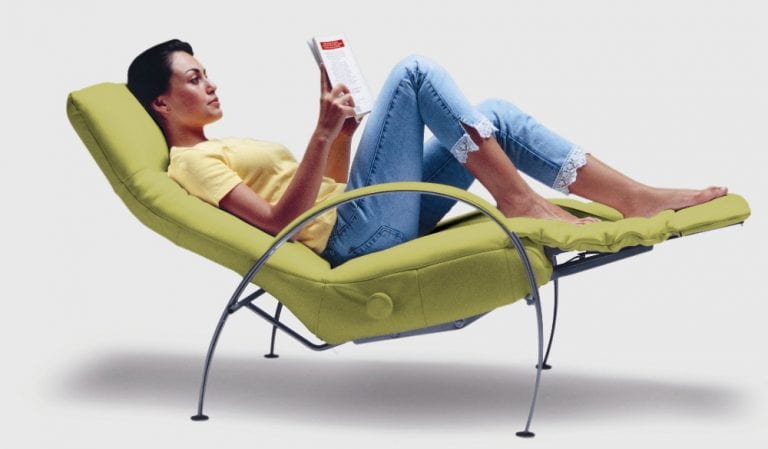 woman reading book in a modern recliner